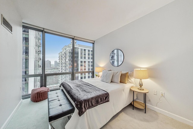 carpeted bedroom featuring expansive windows and multiple windows