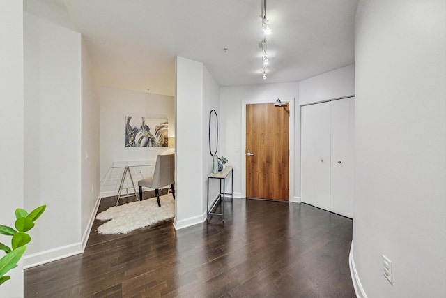 foyer featuring dark hardwood / wood-style flooring and rail lighting