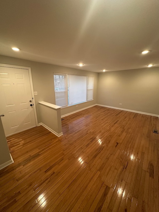 unfurnished room with dark hardwood / wood-style flooring