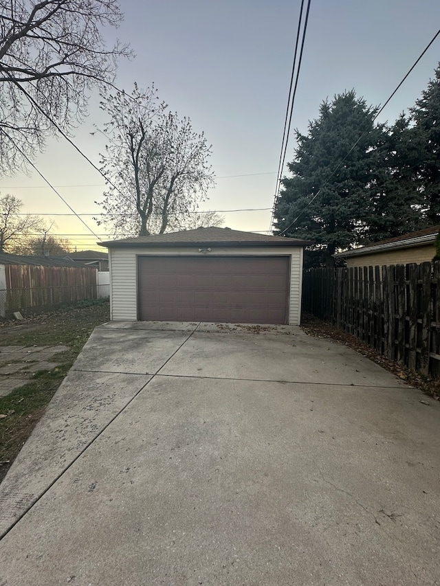 view of garage at dusk