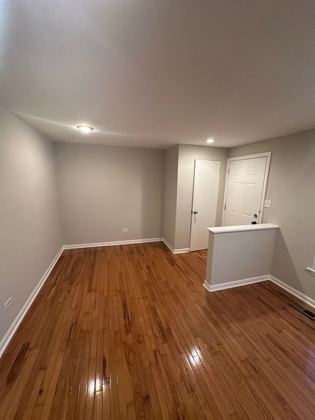 basement with hardwood / wood-style floors