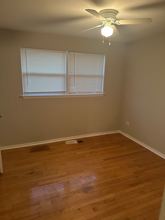 unfurnished room with wood-type flooring and ceiling fan