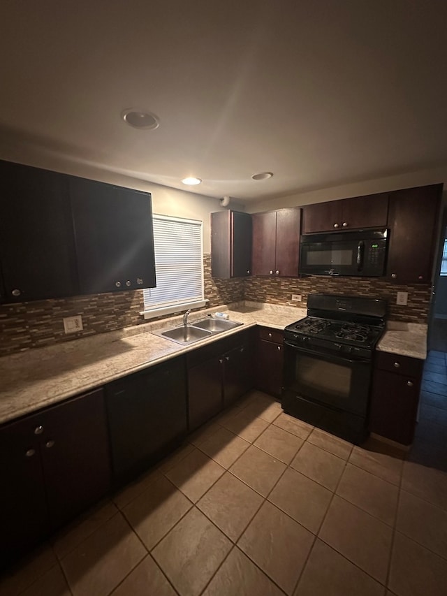 kitchen with decorative backsplash, dark brown cabinetry, black appliances, sink, and light tile patterned floors