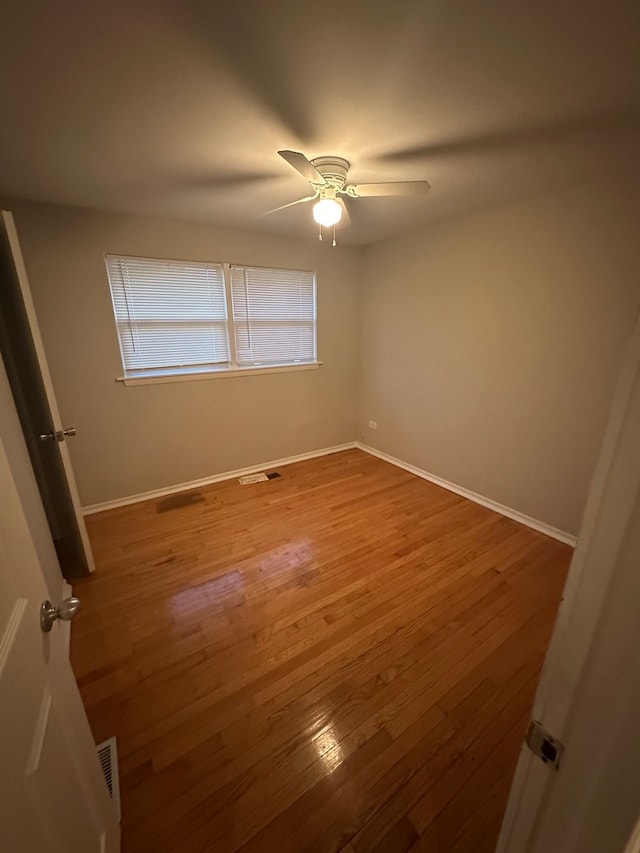 spare room featuring hardwood / wood-style floors and ceiling fan