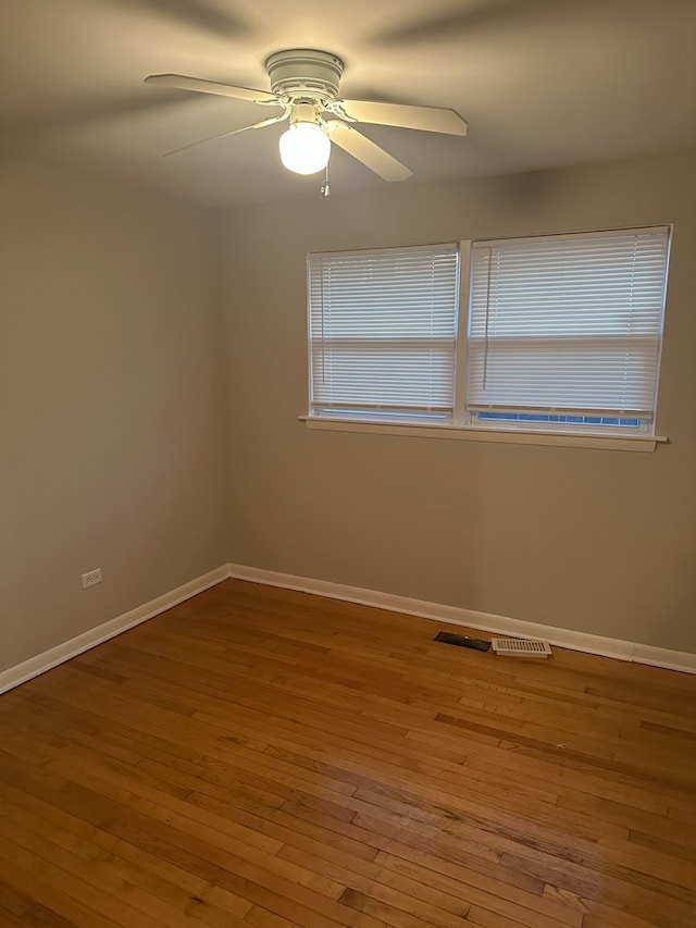 empty room with wood-type flooring and ceiling fan