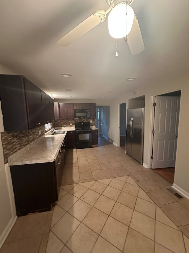 kitchen with black appliances, ceiling fan, light tile patterned floors, dark brown cabinets, and decorative backsplash