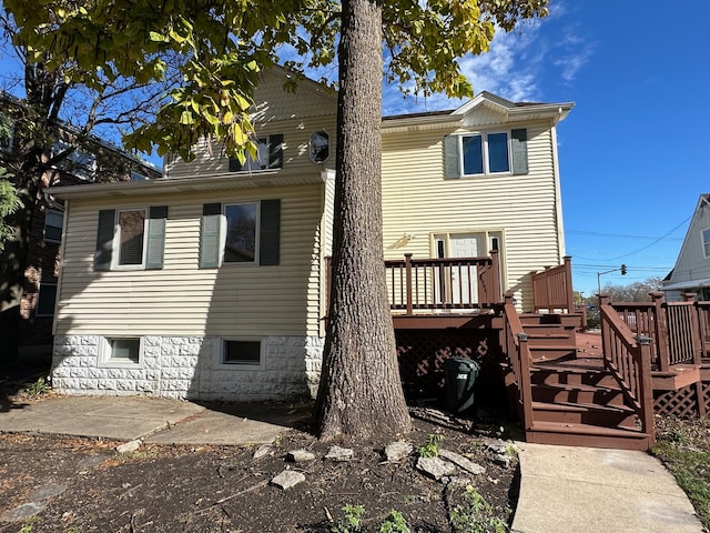 back of house with a wooden deck