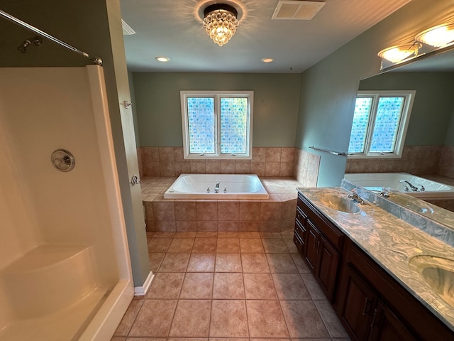 bathroom with vanity, tile patterned flooring, a healthy amount of sunlight, and shower with separate bathtub