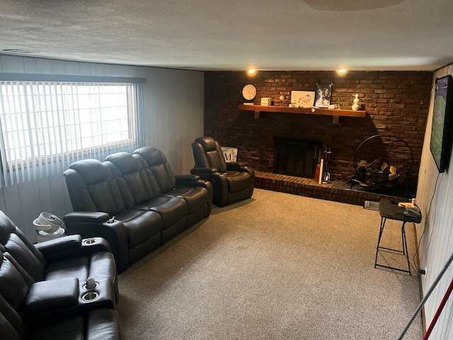 living room featuring a textured ceiling, a fireplace, and carpet