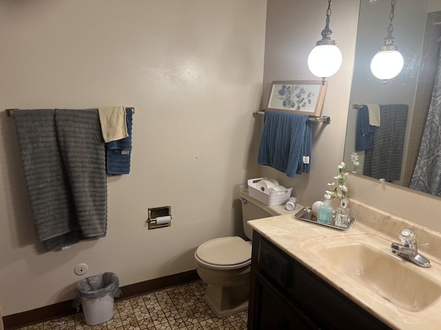 bathroom with tile patterned flooring, vanity, and toilet