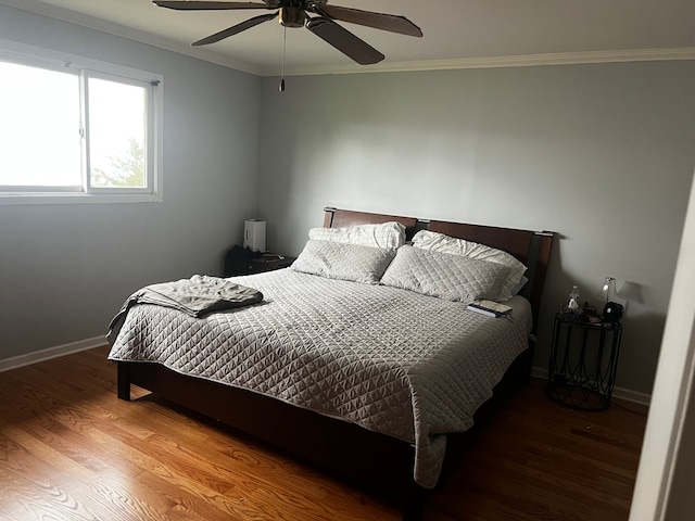 bedroom with ceiling fan, wood-type flooring, and crown molding