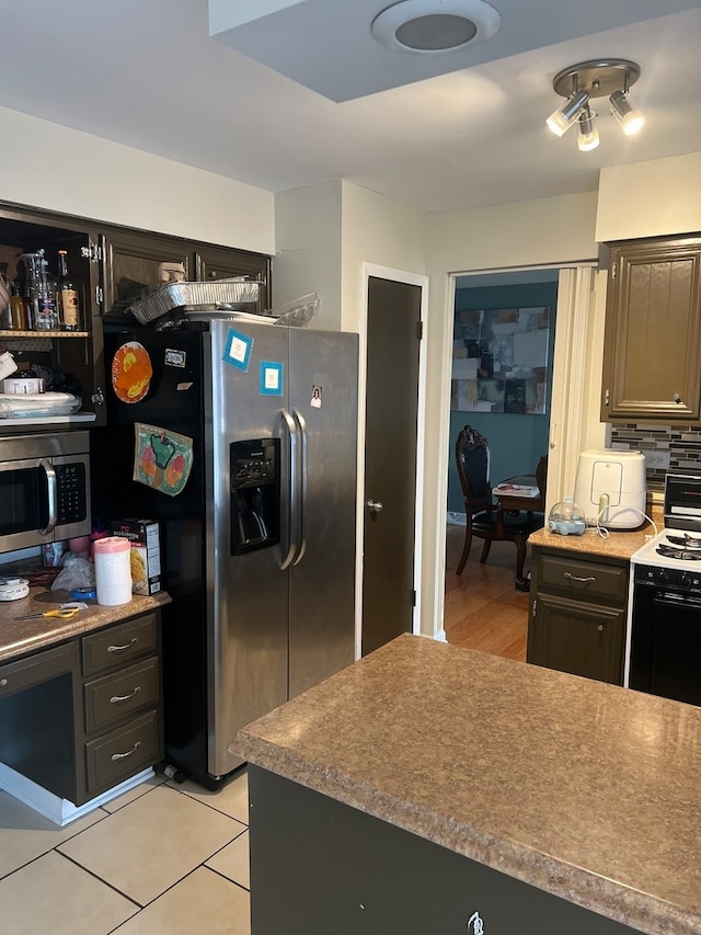 kitchen featuring light tile patterned floors and stainless steel appliances