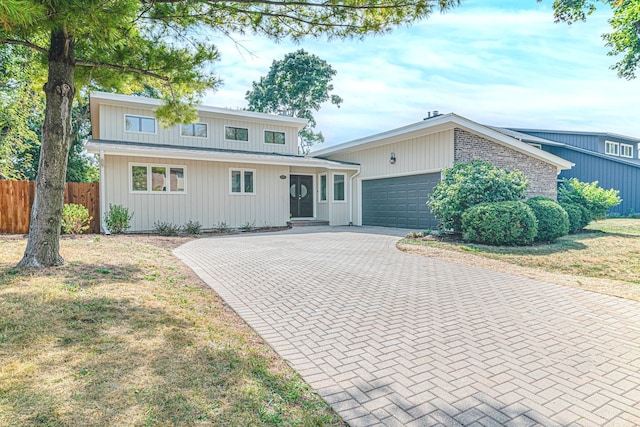 front of property featuring a garage and a front yard