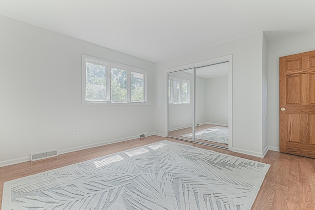 bedroom featuring light hardwood / wood-style flooring and a closet