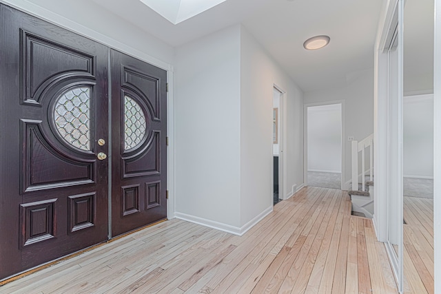 entryway with light hardwood / wood-style floors