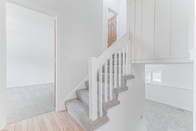 stairway featuring hardwood / wood-style floors