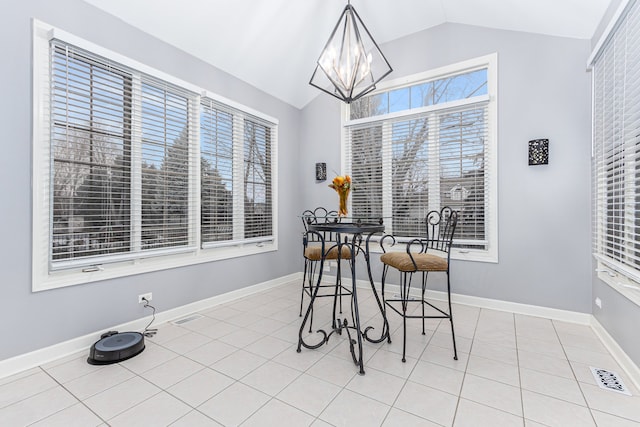 dining space featuring plenty of natural light, light tile patterned flooring, vaulted ceiling, and a notable chandelier