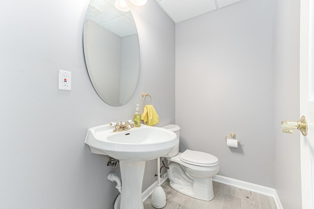 bathroom featuring wood-type flooring and toilet