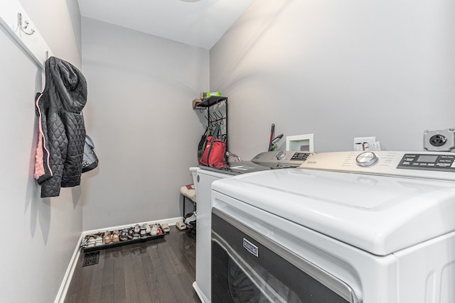 laundry room with washer and dryer and hardwood / wood-style flooring