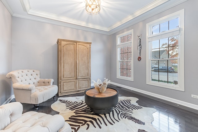 living area with dark hardwood / wood-style flooring and crown molding