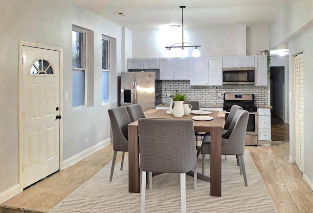 dining space with light hardwood / wood-style flooring