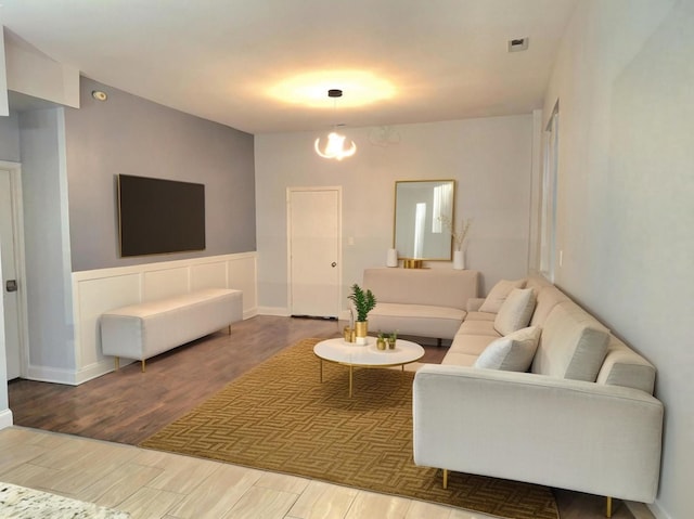 living room with a chandelier and wood-type flooring