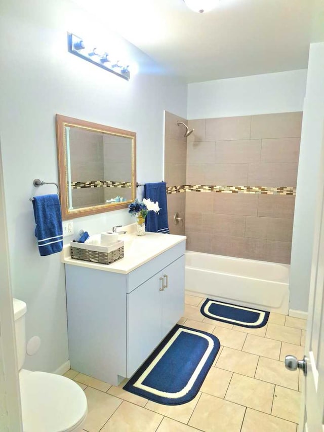 full bathroom with vanity, toilet, tile patterned flooring, and tiled shower / bath combo