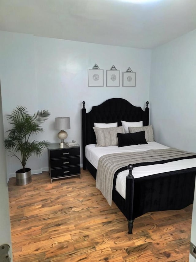 bedroom with hardwood / wood-style flooring