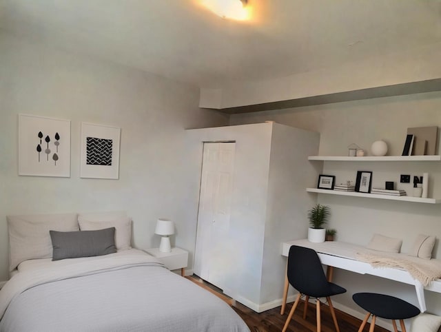 bedroom featuring dark hardwood / wood-style floors and a closet