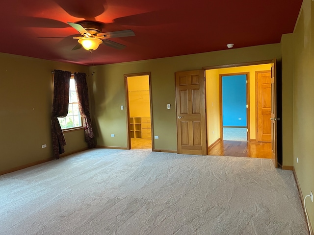 unfurnished room featuring light carpet and ceiling fan