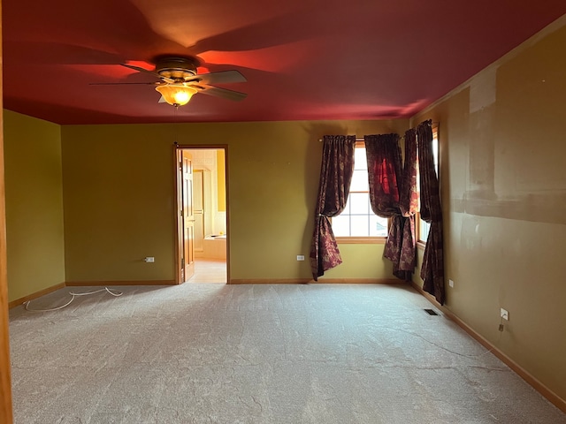 unfurnished room featuring light carpet and ceiling fan