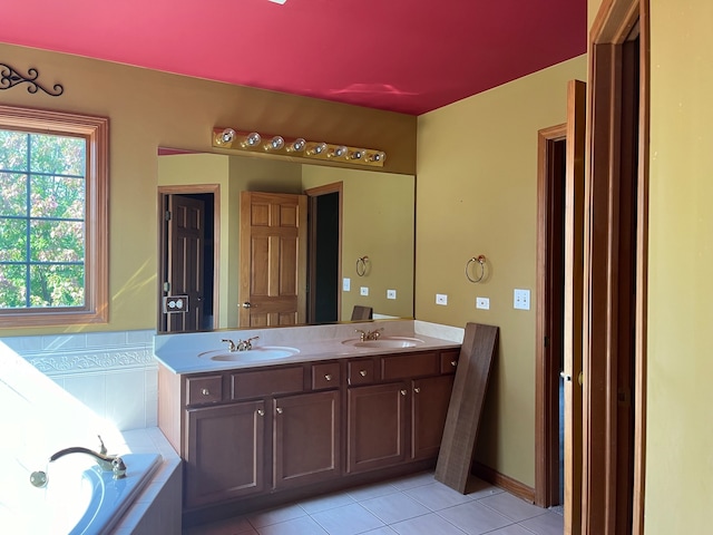 bathroom with a relaxing tiled tub, tile patterned flooring, and vanity