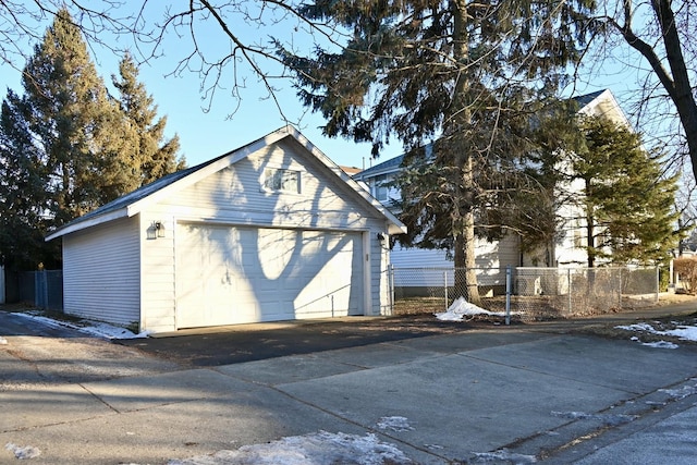 view of property exterior featuring a garage and an outdoor structure