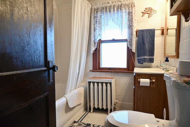 full bathroom with toilet, tile walls, radiator heating unit, vanity, and shower / bath combination with curtain