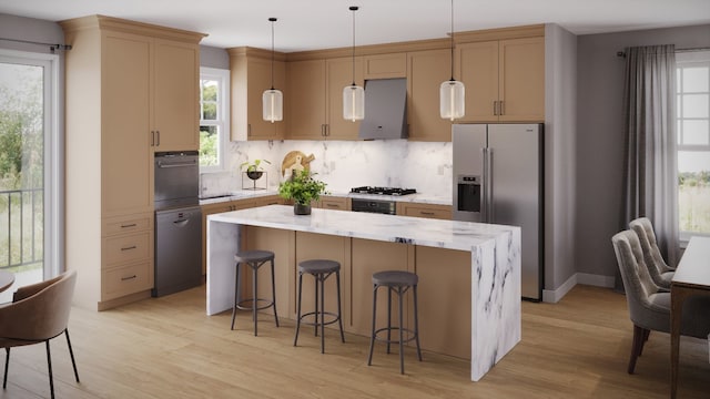 kitchen featuring hanging light fixtures, a kitchen island, stainless steel appliances, and light hardwood / wood-style floors