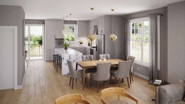 dining area with plenty of natural light and light hardwood / wood-style floors