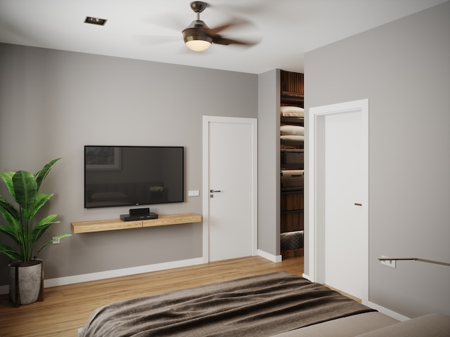 unfurnished bedroom with ceiling fan and hardwood / wood-style flooring