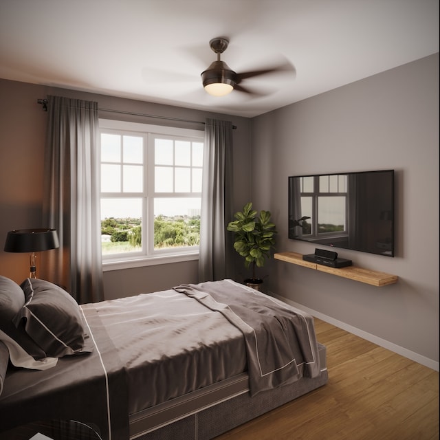 bedroom with multiple windows, hardwood / wood-style floors, and ceiling fan