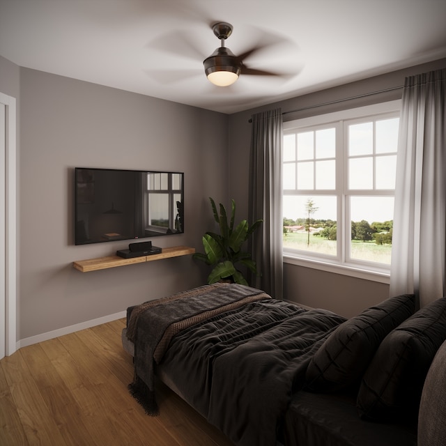 bedroom with ceiling fan and hardwood / wood-style flooring