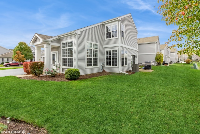 rear view of house featuring a yard