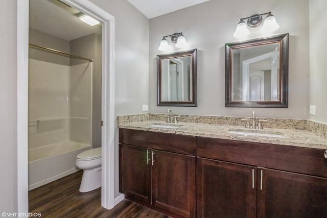 full bathroom with vanity, toilet, wood-type flooring, and washtub / shower combination