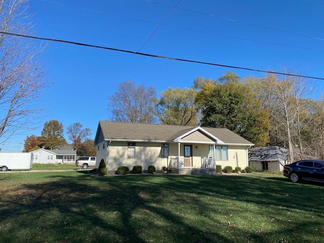 view of front of house with covered porch and a front lawn