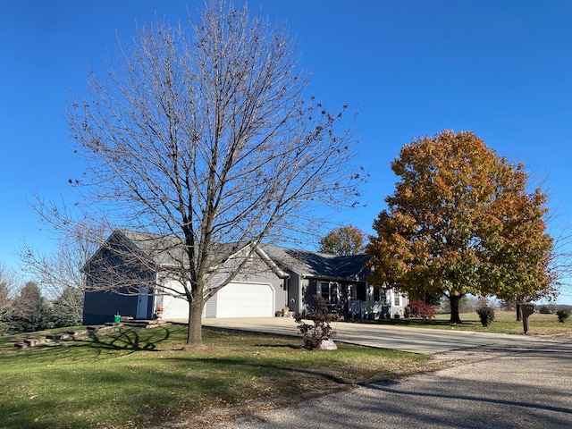 view of front of property with a garage and a front yard