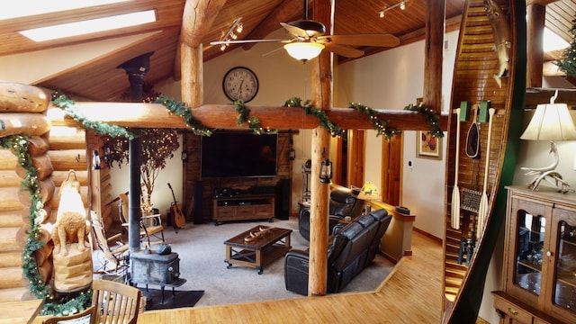 living room featuring light wood-type flooring, lofted ceiling with skylight, rustic walls, and wood ceiling