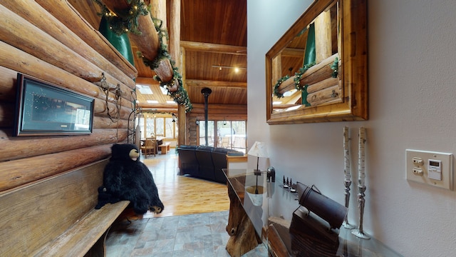 hallway featuring log walls and light hardwood / wood-style floors