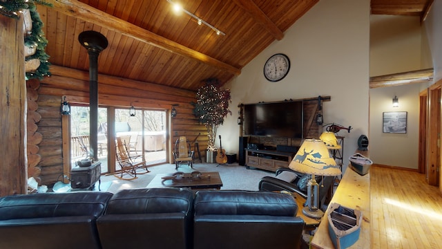 living room featuring high vaulted ceiling, light wood-type flooring, rustic walls, beamed ceiling, and wood ceiling