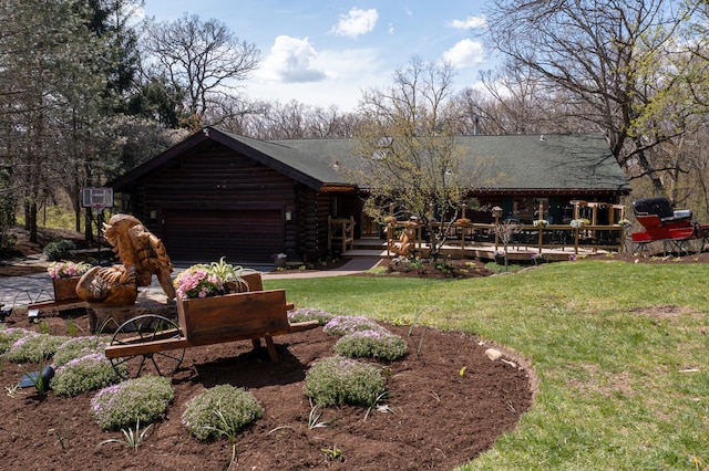 exterior space with a yard and a garage