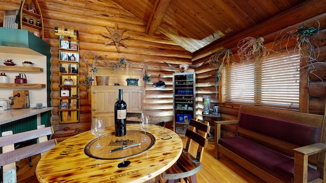 dining room featuring light wood-type flooring, log walls, lofted ceiling with beams, and wood ceiling