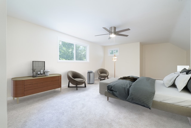 bedroom with ceiling fan, vaulted ceiling, and light colored carpet