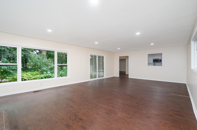 unfurnished living room with dark hardwood / wood-style floors